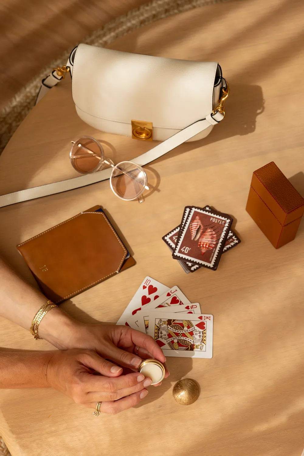A brass globe with playing cards and a handbag