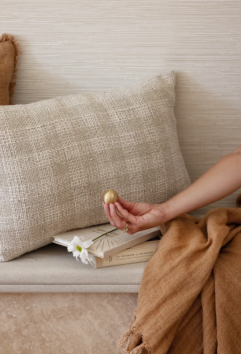 Holding a brass globe on a rattan seat